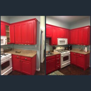 Bright red kitchen cabinets with appliances.