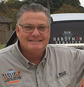 Smiling handyman in professional attire.