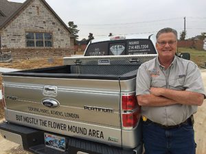 Smiling man beside a Ford truck.